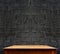 Black brick wall and wooden table,perspective background