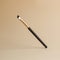 A black brow brush hangs in the air. Makeup brush on an isolated background.
