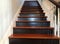 Black and brown wood stairs with white railing