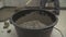 Black bucket with mortar for filling the floor. Bucket with mortar at the construction site