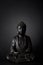 Black buddha meditating statue