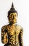 Black Buddha Statue covered with small Gold Plates isolated on W