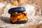 Black burger delivery.Delicious fast food delivered in crafted brown paper.Big tasty cheeseburger with burned cheddar cheese,