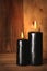 Black burning candles on wooden background