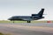 Black business jet taxiing from the runway