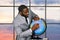 Black businessman pointing at globe.