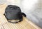 Black camera bag on bamboo floor