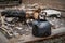 Black camping kettle stands on benches in the forest