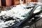 Black car crashed under white raw snow