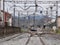 Black car crossing a level crossing over the train tracks