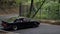 Black car extreme speed turn in drift on narrow countryside road. Japanese jdm car