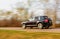 Black car speeding on road