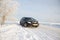 Black car on winter snowy road . Winter road. Journey. Russia, Gatchina 22 January 2019