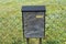 Black carved mailbox with spring flowers background