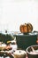 Black cast iron cooking pot with pumpkins on kitchen table background with ingredients at window. Autumn cooking