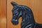 Black cast iron horse head. Door stop. Pine door.