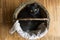 Black cat lying in a wicker basket