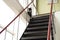 Black cat with white collar protects the steep metal stairs