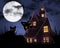 Black cats, full moon and a haunted house at night are seen i