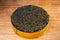 Black caviar in cardboard box. Spooning black caviar