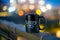 Black ceramic mug with indian coffee startup sleepy owl on the side with bokeh balls of light in the background