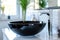 Black ceramic round sink and chrome faucets in the bathroom. Minimalist modern bathroom interior design