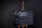 Black chalkboard with coffee menu and streaks erased chalk. Stands on a wooden easel, isolated on a dark background