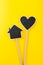 Black chalkboard heart and house on a wooden stick. Mothers day