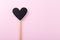 Black chalkboard heart on a wooden stick. Valentines day background