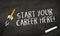 Black chalkboard with pencil rocket and message Start your career here