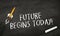 Black chalkboard with written words Future begins today and pencil rocket