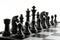 Black chess pieces on the chessboard on white background