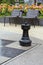 Black chess rock is on the street chessboard with two chairs