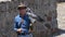 Black-chested Buzzard-Eagle standing on the hand with leather glove of the trainer of falconry. Scientific name: Geranoaetus