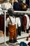 A black children`s mannequin in a shirt and trousers with suspenders in a shopping center. Children`s casual clothing store