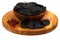 Black chips in a wooden plate with red pepper