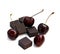 Black chocolate lump and dark large cherry isolated on white