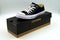 Black Chuck Taylor Converse All Star low top standing on a retail box