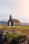 Black church in the meadow and field in Iceland. Icelandic scenic travel destination of religion.