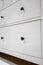Black circle handle on white drawers with depth of field