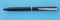 Black classic ballpoint pen on blue background