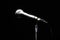 Black classic microphone on black dark background. Music and concert concept.