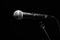 Black classic microphone on black dark background. Music and concert concept.