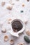 Black clay around  marine salt and shells background. Healthy concept. flat lay