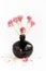 Black clay pomegranate on a white background. original vase in the form of a pomegranate. dried flowering onions with