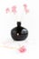Black clay pomegranate on a white background. original vase in the form of a pomegranate. dried flowering onions with