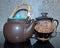 Black clay teapot with bamboo handle and a vase for honey with the inscription `Honey`. Cooking battery. Latgale ceramics