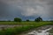 Black clouds and rain over the field in farming season