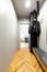 Black coats on a creative, industrial hanger in an entrance inte