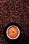 Black coffee cup hot espresso closeup top view beans background